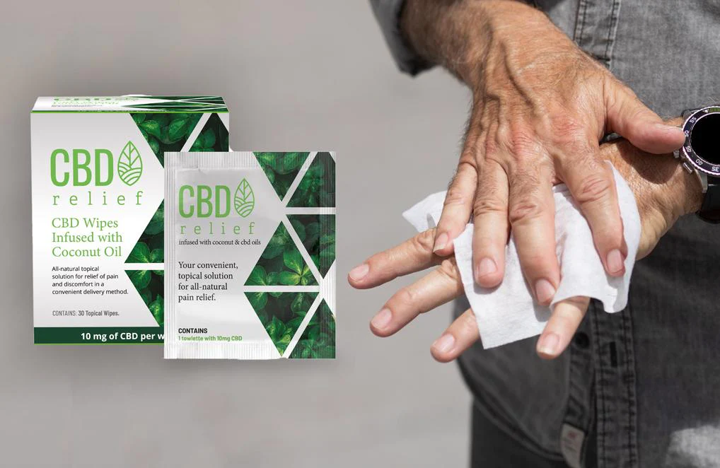 Two boxes of CBD WIpes and a close uip of a man's hands as he uses them